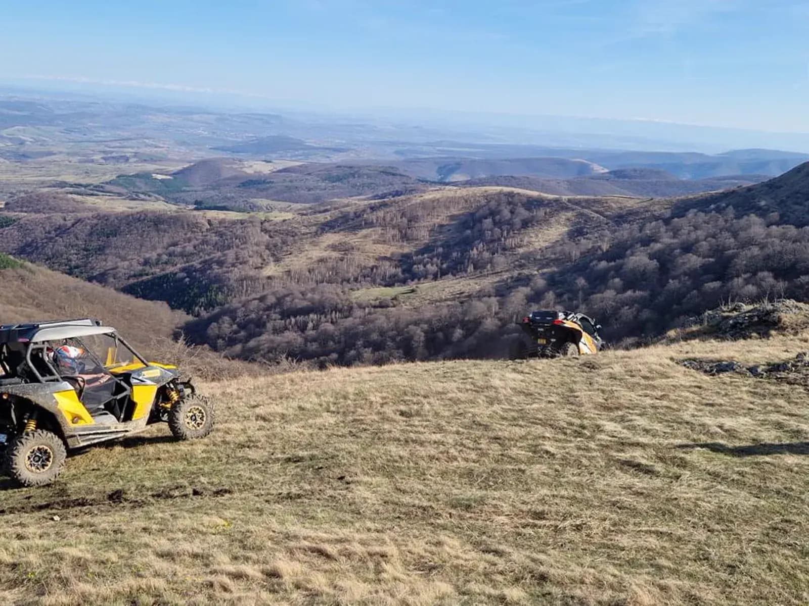 Two buggies overlooking a layered mountain valley
